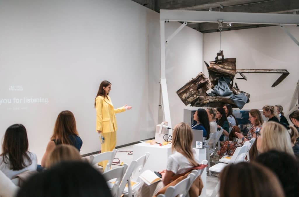 A speaker in yellow leading a workshop for the Curious Cardinals community.